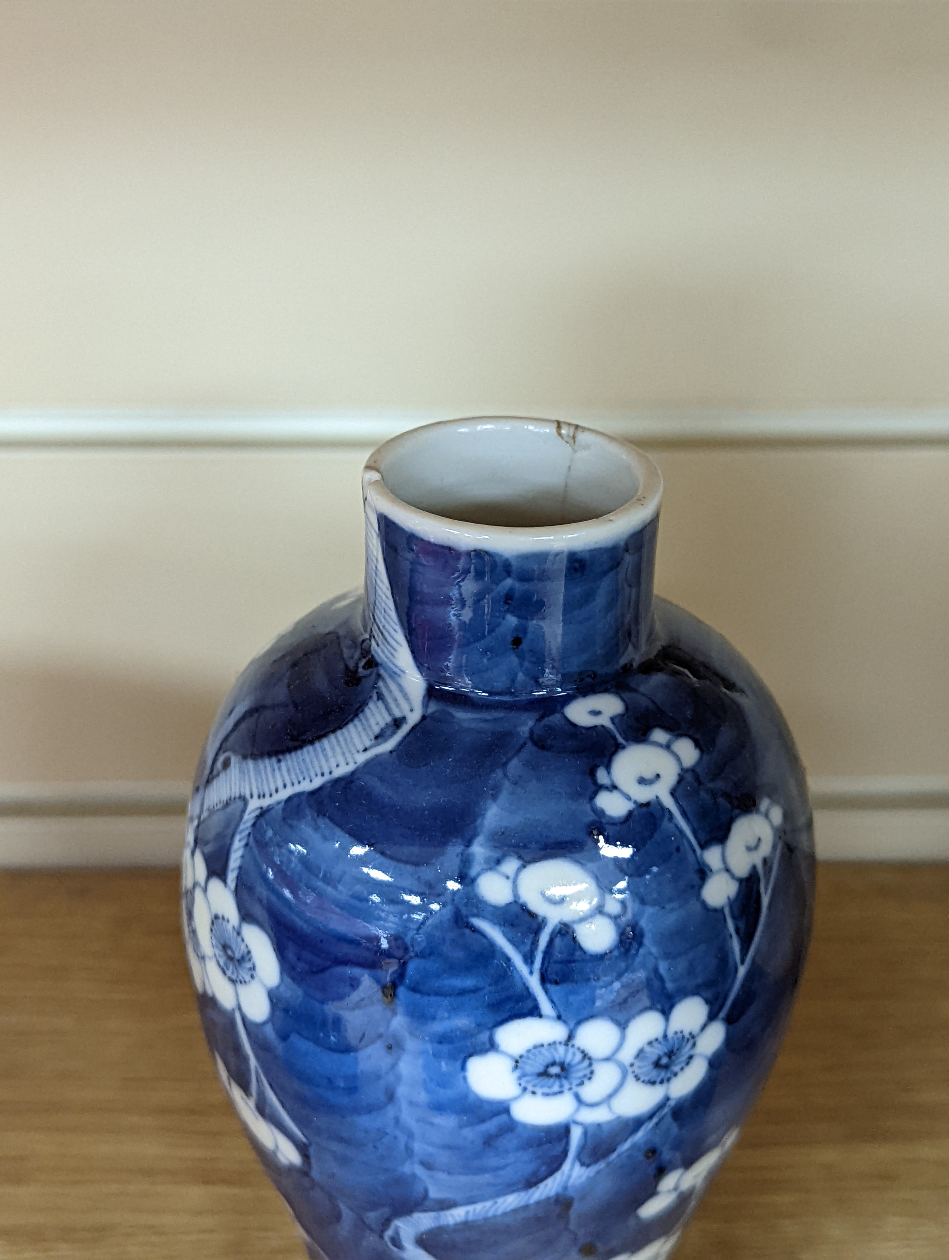 A pair of 19th century Chinese blue and white vases, a prunus vase and cover and a similar jar (4), pair of vases 24 cms high.